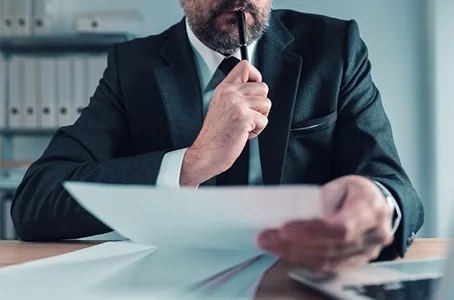 Lawyer reviewing documents with pen
