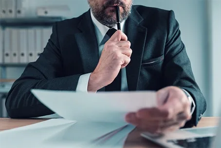 Lawyer reviewing documents with pen