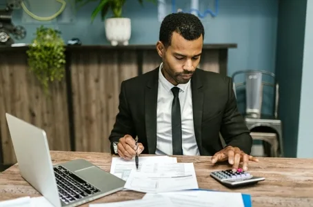 Accountant reviewing bills with calculator