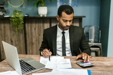 Accountant reviewing bills with calculator