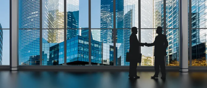 Business partners shaking hands with a litigation attorney