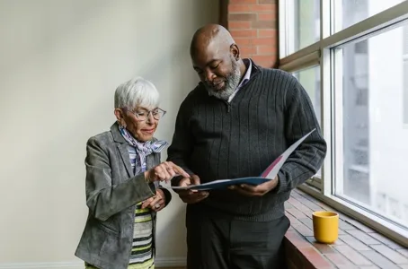 Advisor reviewing document with senior woman