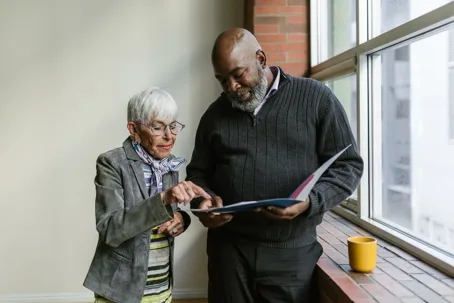 Advisor reviewing document with senior woman