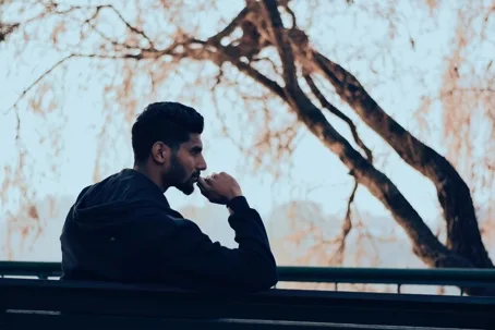 Man sitting on bench, deep in thought