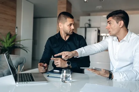 Colleagues discussing data at a laptop