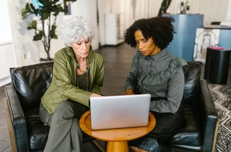 Two women reviewing a laptop