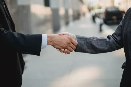 Business handshake on city street