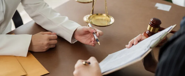 Close-up of lawyer and client reviewing a document