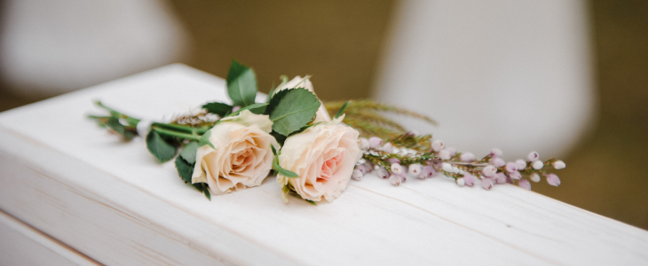 Funeral casket with a rose on top