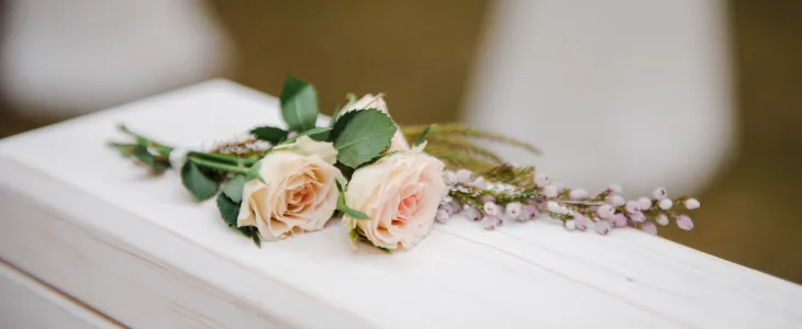 Funeral casket with a rose on top