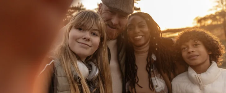 Selfie of a mixed race melded family enjoying life whilst grounding in nature in an autumn park in the Netherlands