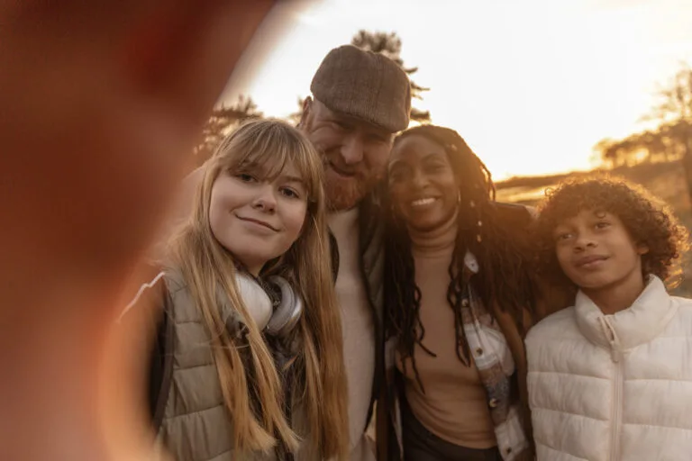 Selfie of a mixed race melded family enjoying life whilst grounding in nature in an autumn park in the Netherlands